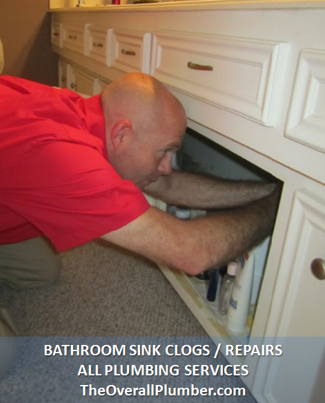 chris-whitworth-owner-of-the-overall-plumber-repairing-a-sink-drain